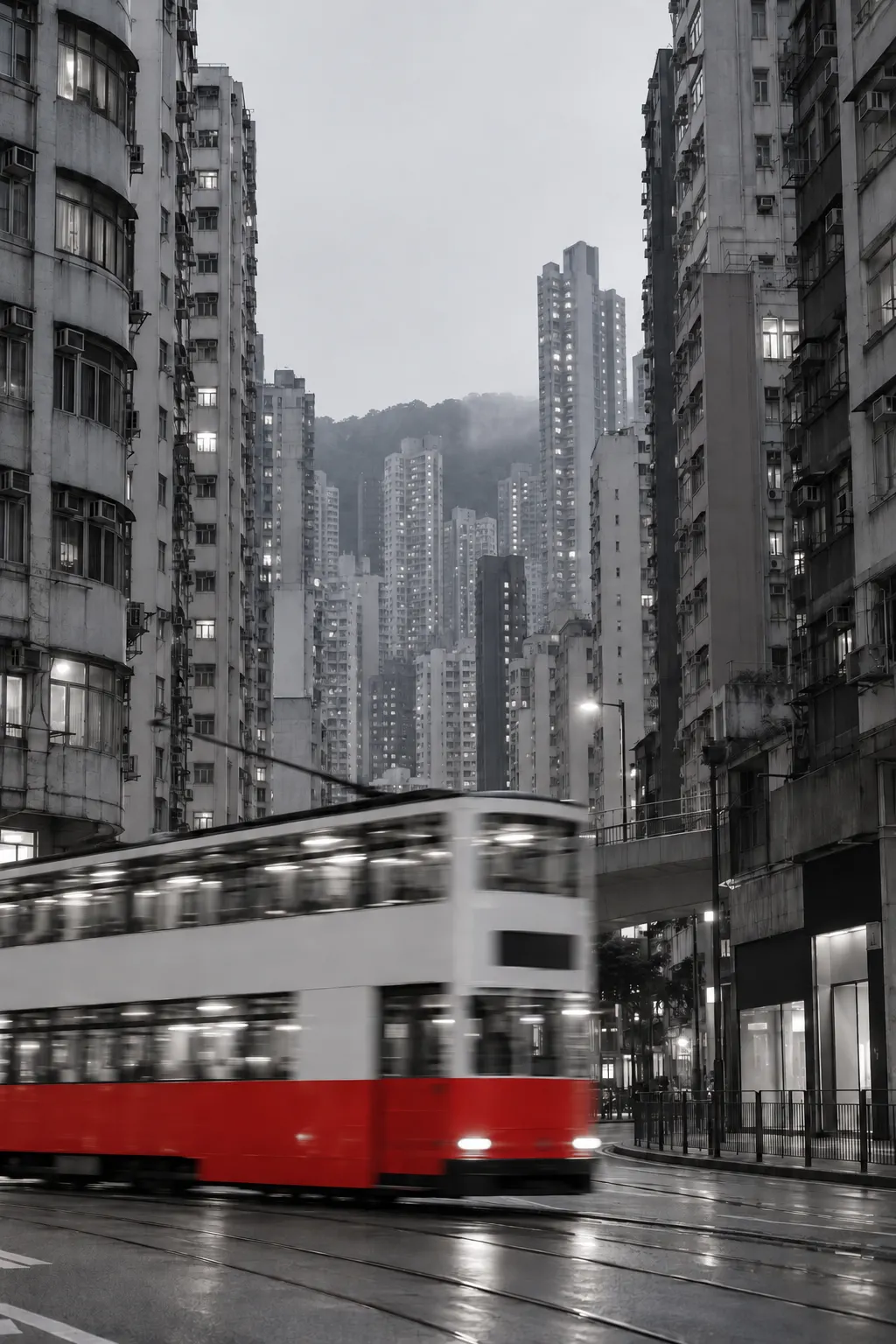 Dense Hong Kong residential towers at dusk with traffic passing below